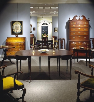 Collection of a few objects from the archive: wooden drawers, tables, chairs.